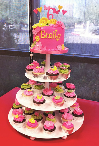 pink green and yellow 6th birthday cupcake tower with flowers and hearts tower display