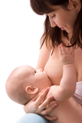 white woman with brown hair breastfeeding a baby