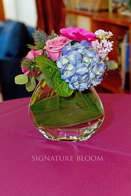 Classic style floral centerpiece in a modern vase wedding flowers used 