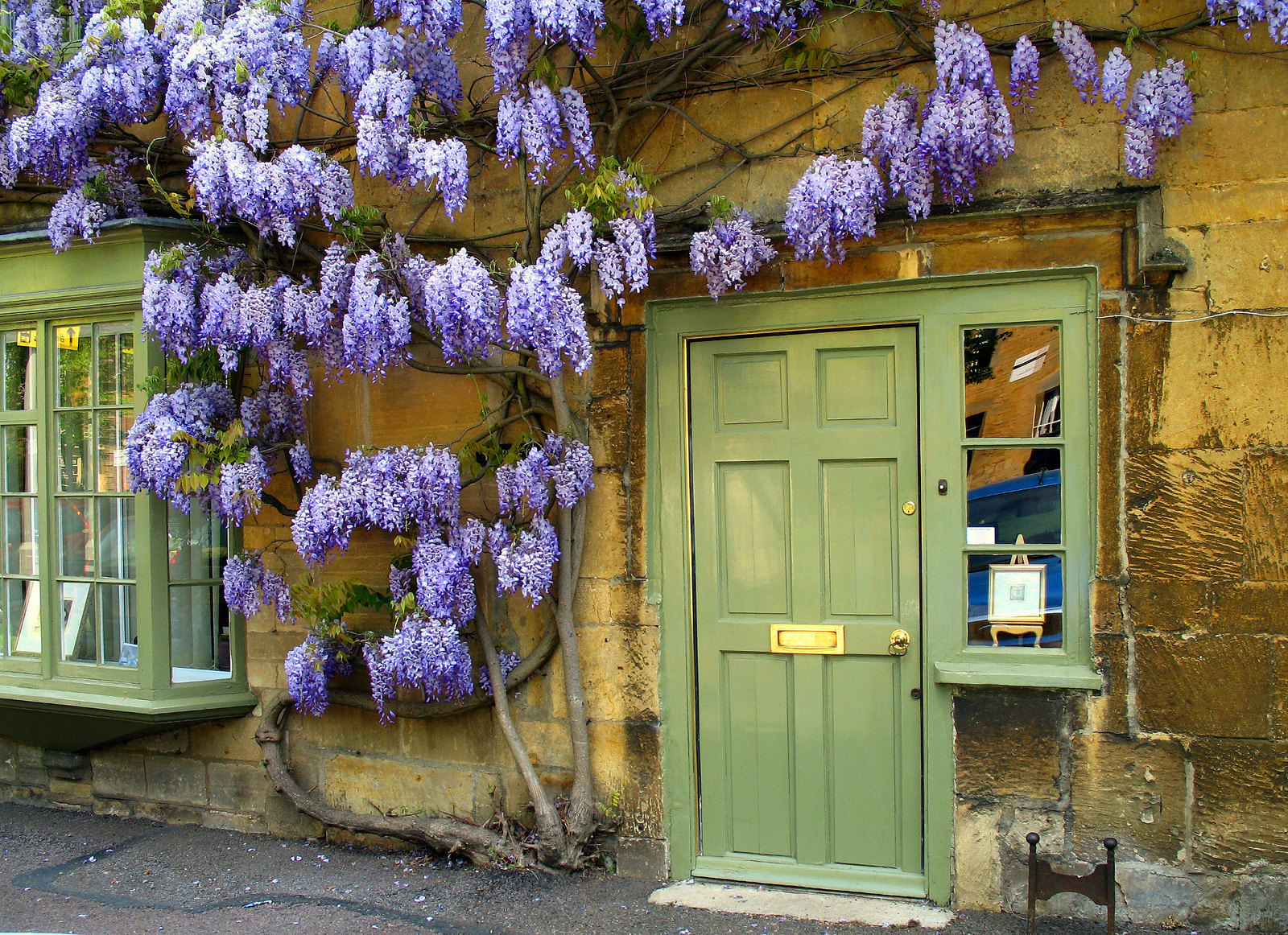 A cottage in Moreton-in-Marsh with wisteria growing round the front door