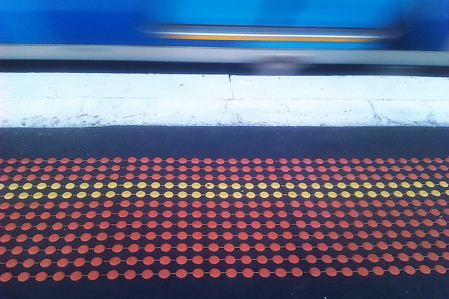 Create a photograph that features a repeating pattern - Platform at train station