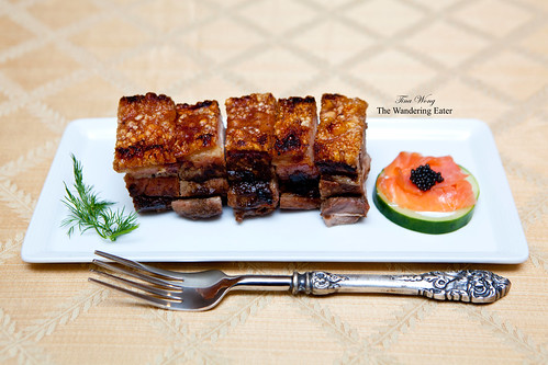 Homemade roast pork belly with a side of cucumber topped with Salmon Fume and Paddlefish caviar