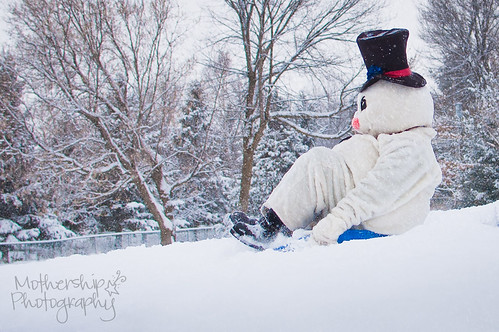 Snowman sledding