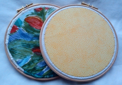 The backs of the embroidery pieces, neatly finished with a circle of cotton