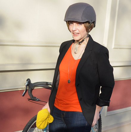 Bikeyface with her bike and cycling bonnet