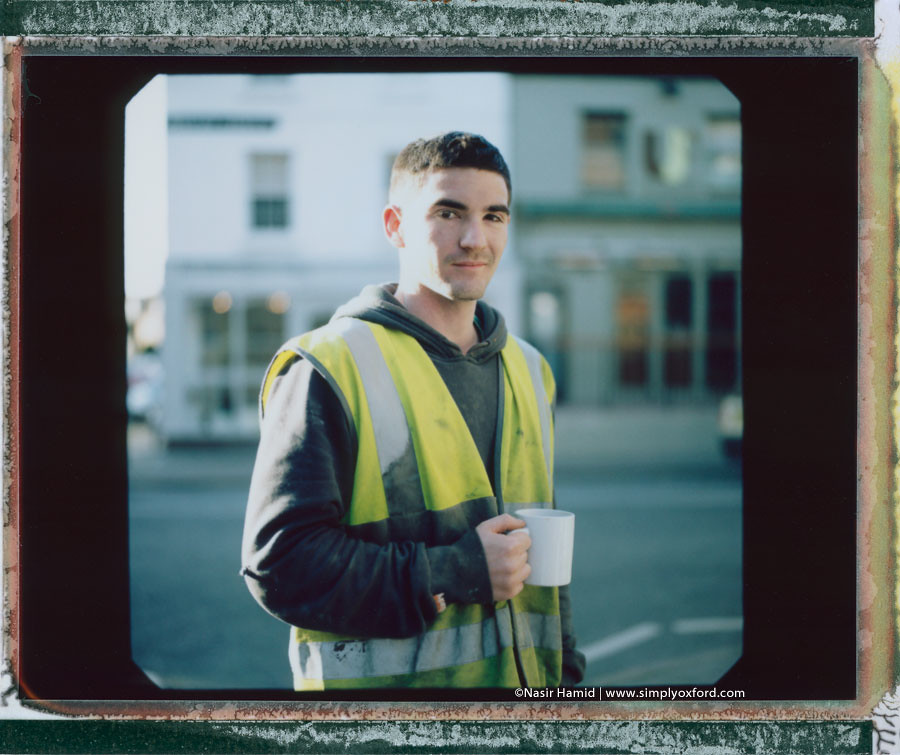 A builder holding a cup of tea
