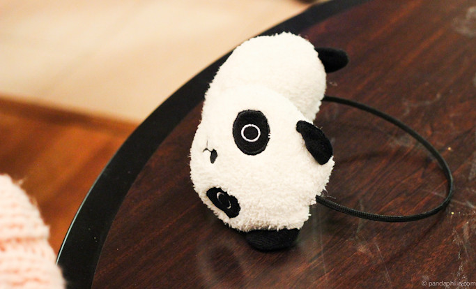 still life: panda earmuffs on a dirty table