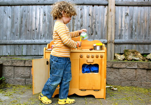 My son playing with his wood kitchen