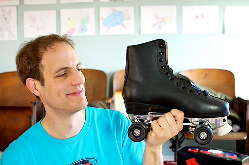 Mark examining his rollerskates.