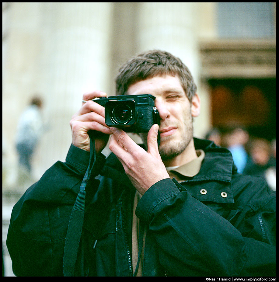 A man using a Leica film camera