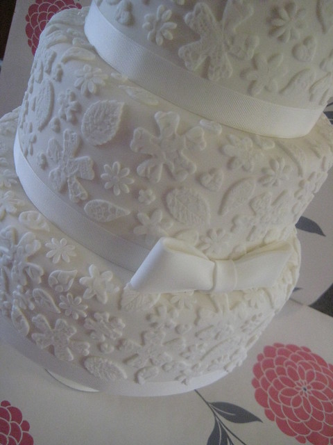 white lace wedding cake Close up of the bow and lace detail