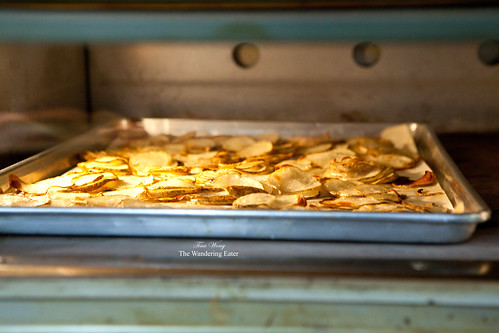 Thin potato slices roasting in the oven