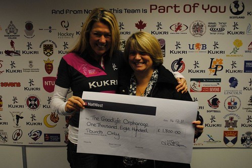 Woody presents the cheque to Mary