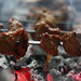Meat pieces being grilled at coals BBQ