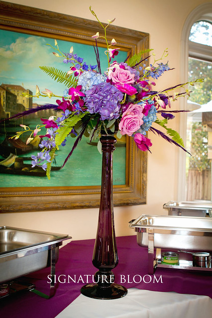  purple feathers and foliage For more reception centerpiece ideas 