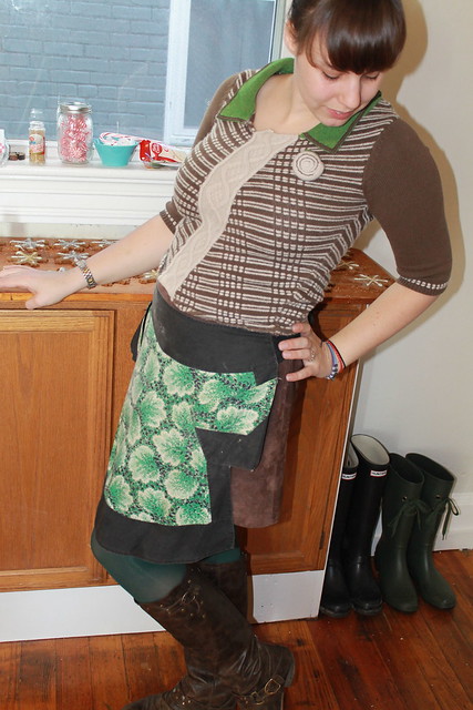 Christmas eve outfit: green tights, leather boots, vintage suede mini skirt, Anthopologie sweater, vintage apron