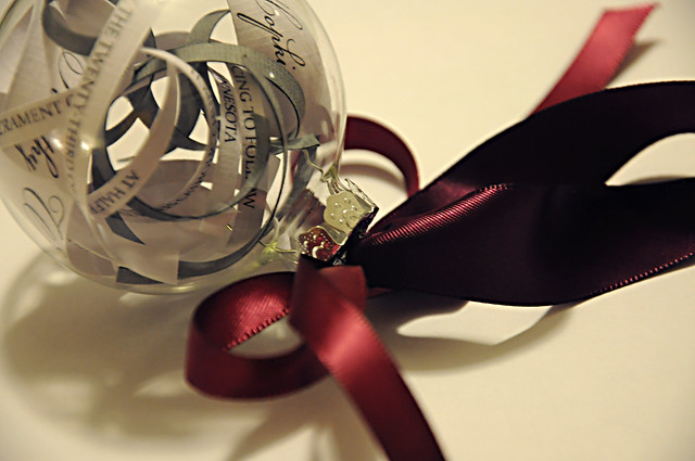 Curled slices from our wedding invitation fill this classy glass ornament