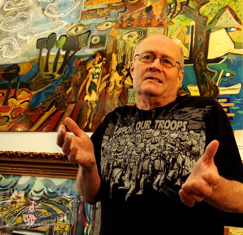 Karl Krogstad, shrugging gesture, in black Support Our Troops (Storm Troopers) T-shirt, fashion, fine artist, paintings, Ballard, Seattle, Washington, USA by Wonderlane