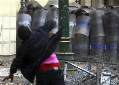 Protester throws stone at security forces who have attacked demonstrators since the beginning of December 2011. The North African state has been the scene of ongoing protest since January. by Pan-African News Wire File Photos