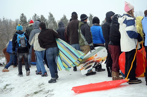 Staying on their feet, crowd watching the action, sledders with all kinds of sleds including a sofa!, plastic sheets, disks, fancy boards, top of the big hill, snowy trees, Lake Union, Gas Works Park, Eastlake / Wallingford, Seattle, Washington, USA by Wonderlane