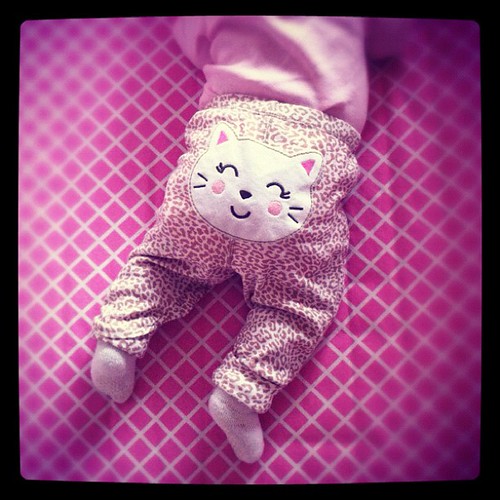 6 weeks old & tummy time in her 6 month pants.