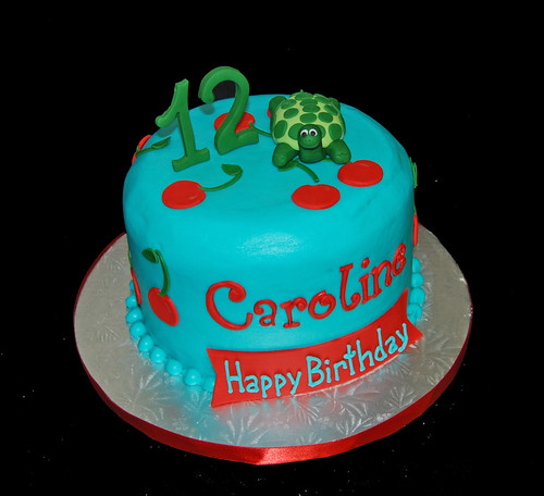 12th birthday cake with cherries and topped with a turtle