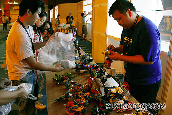 Collectors busy at work, preparing their toys for display
