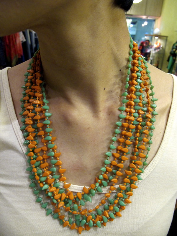 See? See? We love! Orange and green teeny weeny teardrop-shaped beaded multi-strand necklace that you can loop around in a few ways and are too cute for words. We gotta stop using the word cute.