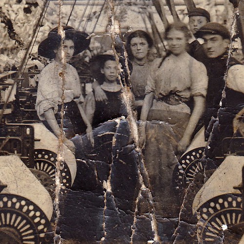 Workers amidst the looms in Oswaldtwistle textile mill, Oswaldtwistle, Lancashire. Decorated for the 1910 coronation. (enlarged detail)