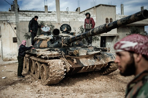 A Free Syrian Army member prepares to fight with a tank