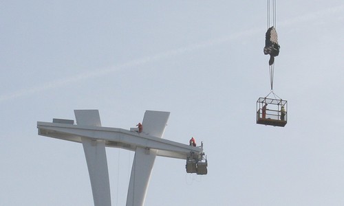People working on the top of the Cable Car pylon