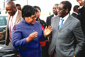 Zimbabwe President Robert Mugabe being greeted by Vice President Joice Mujuru upon his arrival from Singapore for an annual holiday. Mugabe is the leader of the ZANU-PF ruling party in this Southern African state. by Pan-African News Wire File Photos