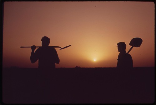 Farm workers shoulder tools at end of day near Ripley, in the fertile Palo Verde Valley of the lower Colorado River region, May 1972