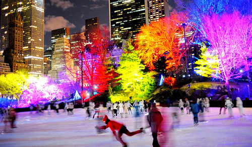 Colored lighting of trees, ice rink in Central Park