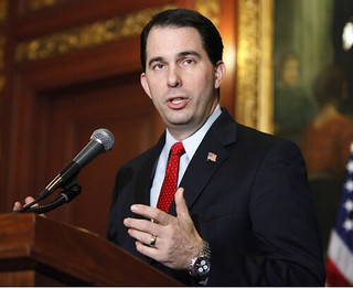 Governor Walker, a white man with dark hair wearing a suit