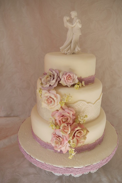 Floral cascade 3 tier wedding cake with lace banding