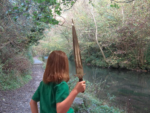 Standing with a sword by a river