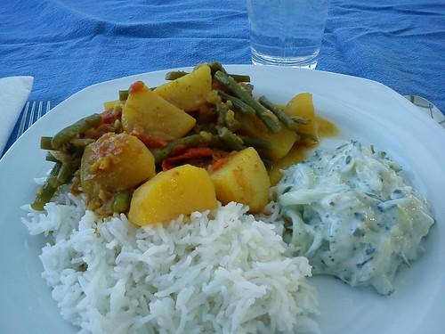 curried potatoes and green beans with rice and cucumber raita