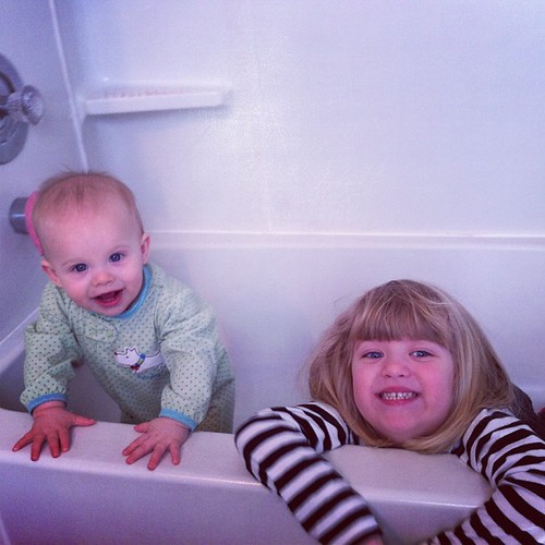 Catie thought it would be funny to get in the empty tub with her clothes on. Lucy agreed. Goofy kids.