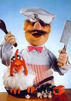 Swedish muppet chef about to cook a live chicken in frying pan