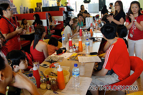 Bloggers briefing by Angela (standing, in black top) from Far East