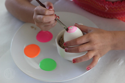 child painting an egg 