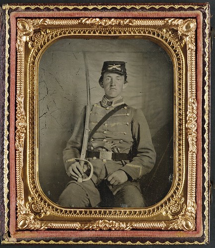 [Private David M. Thatcher of Company B, Berkeley Troop, 1st Virginia Cavalry Regiment, in uniform and Virginia sword belt plate with Adams revolver and cavalry sword] (LOC) by The Library of Congress