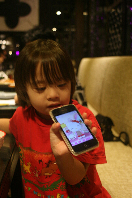 Nadine with best babysitter ever - the iPhone