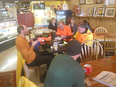 A gaggle of randonneurs sit down for a snack in Silverton