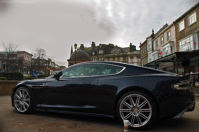 A profile shot of an awesome Dark Blue Aston Martin DBS parked in front of