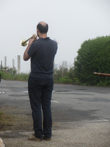 playing taps by the water for those lost at sea