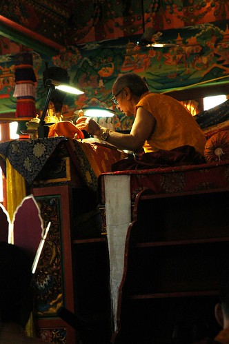 His Holiness Dagchen Rinpoche giving a highest yoga tantra initiation, crowned initiate in foreground, seated on his throne, ringing a vajra handled bell, Sakya Lamdre, Tharlam Monastery of Tibetan Buddhism, Boudha, Kathmandu, Nepal by Wonderlane