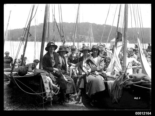 Women sitting on beached skiffs in Sydney Harbour