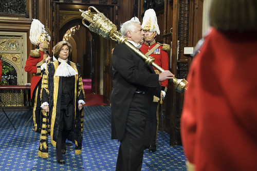 The Lord Speaker, accompanied by the mace and doorkeepers, makes her way to Sovereign's Entrance to await the arrival of the Queen